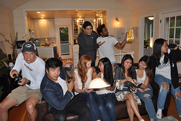 group of students at a house using different technologies
