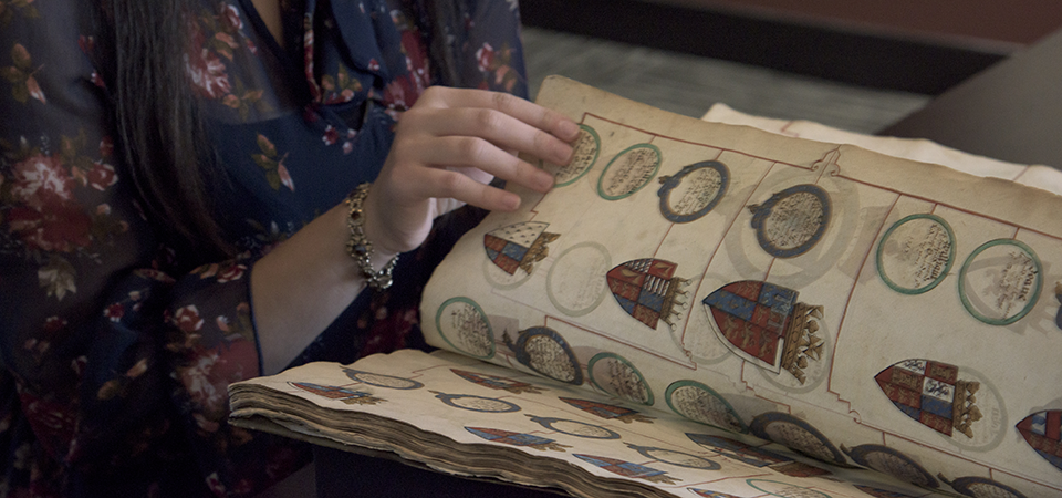 girl flipping book on old book