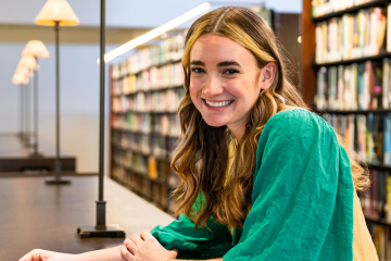 student smiling in library