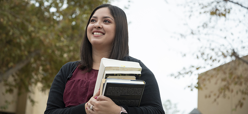 image of woman holding books