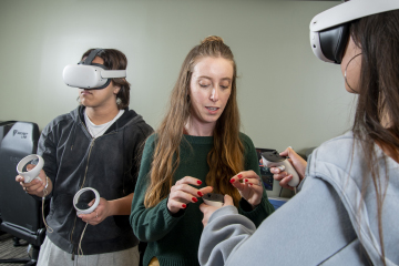 librarian showing students how to use VR in the Genesis Lab