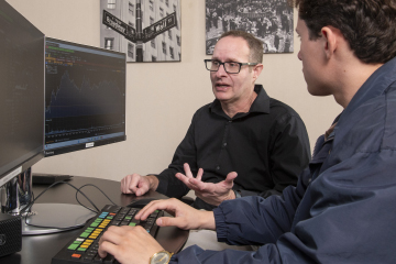 librarian and student talking in front of a computer