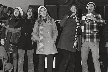 Students singing Christmas carols at Convocation, circa 1974