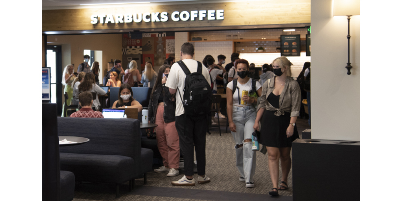 Students wearing masks in front of Starbucks