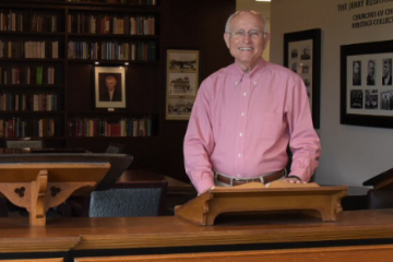 portrait of Jerry Rushford in front of historic pulpit