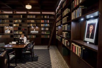 Interior view of Payson Library with man working on laptop