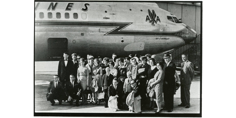 students in front of airplane