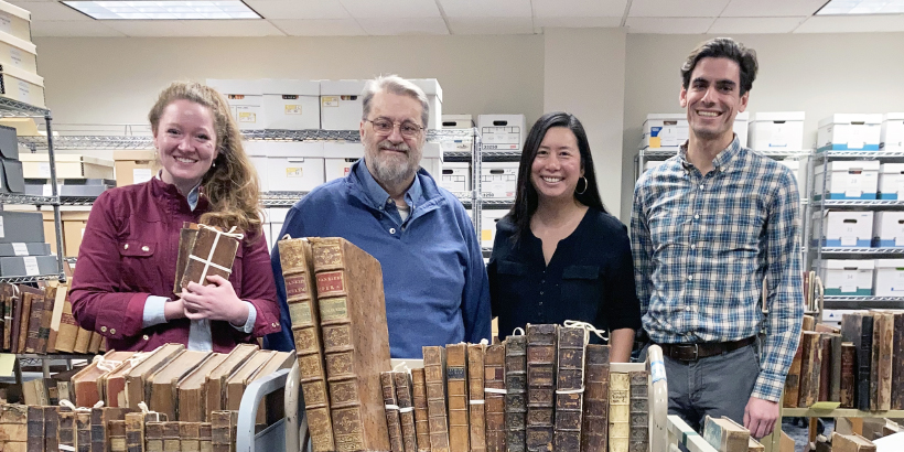 HUTE faculty looking at books