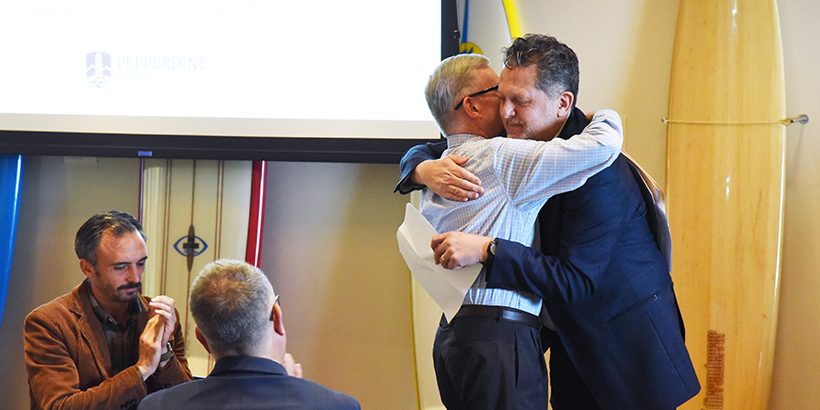 Dyron Daughrity and Douglas Foster hugging